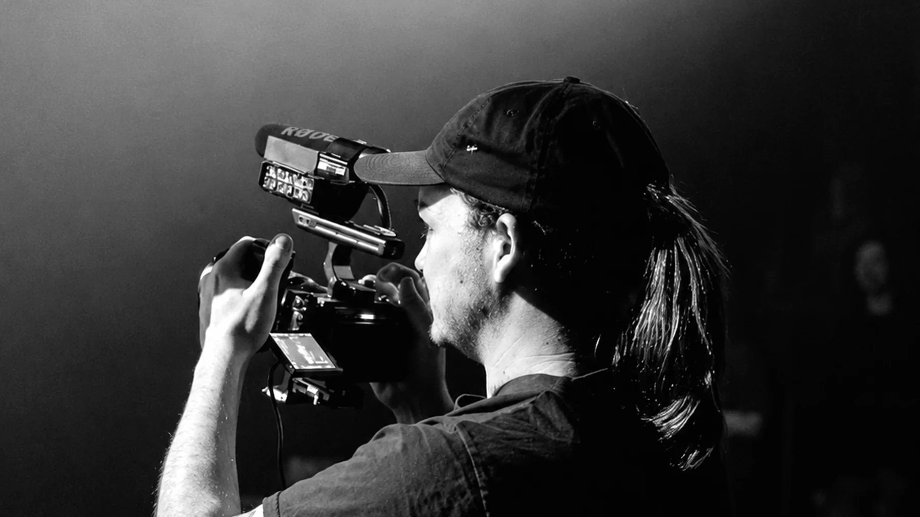 Reeka Studios about page image 4 — camera operator under stage lights