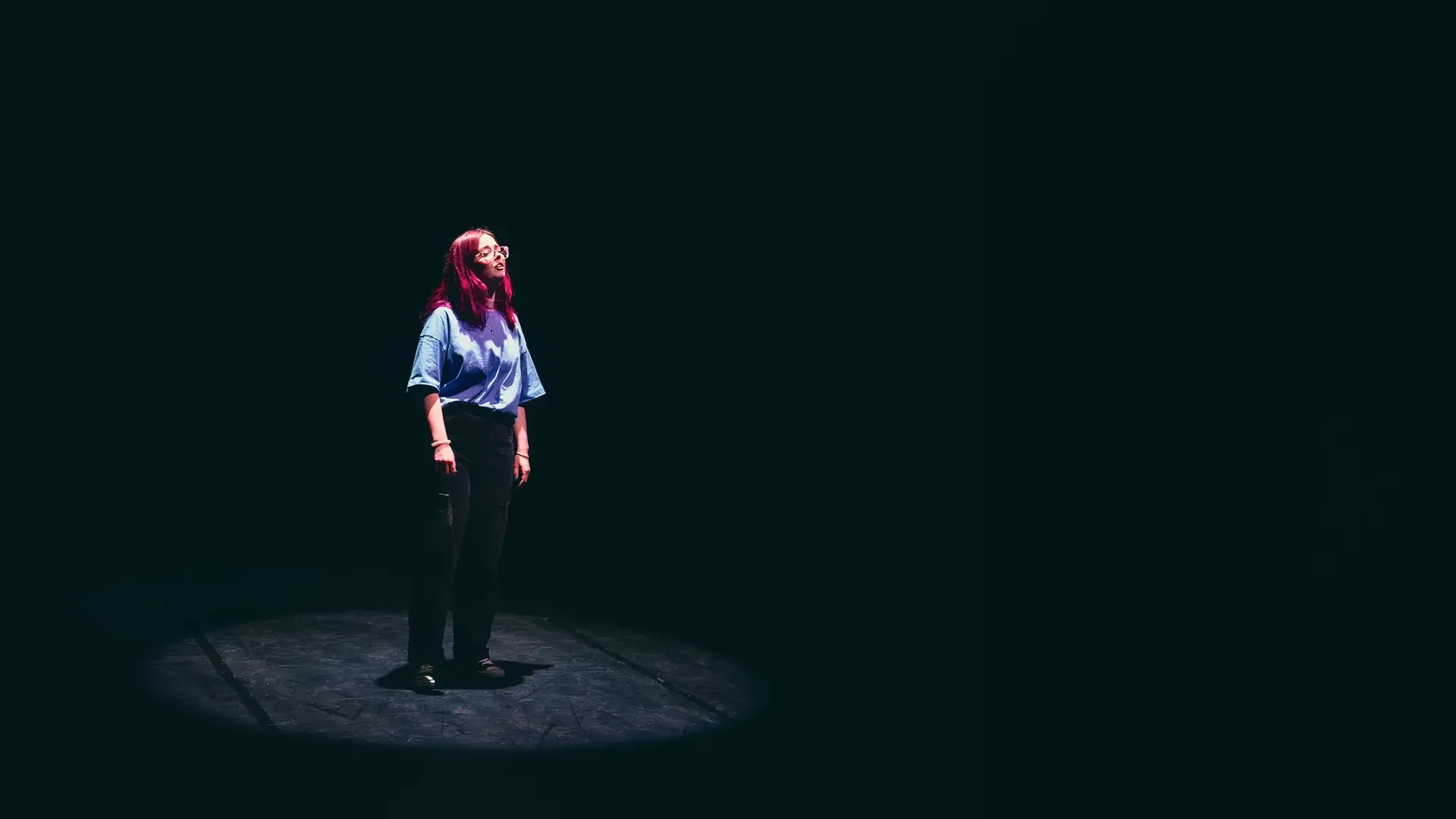 30 Day Free Trial performance still with a performer isolated under stage lighting