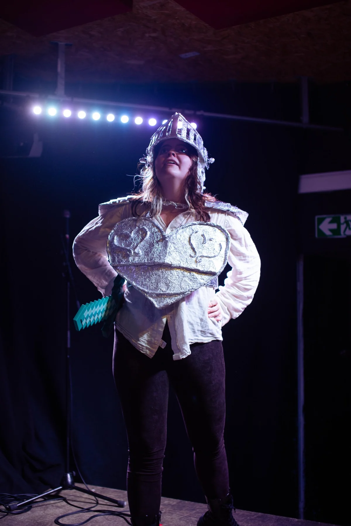 Scratch and Tickle performer in handmade armour on stage