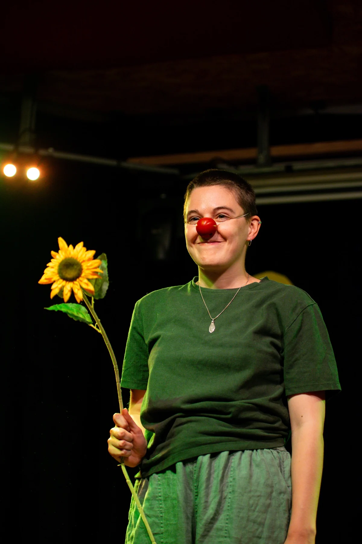 Scratch and Tickle performer with clown nose and sunflower