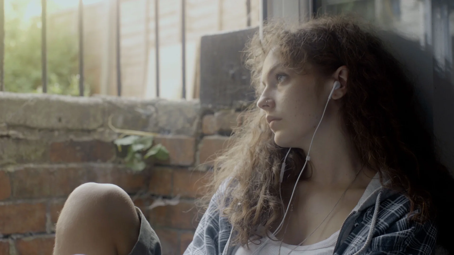 Sam seated beside the window in Disclosure