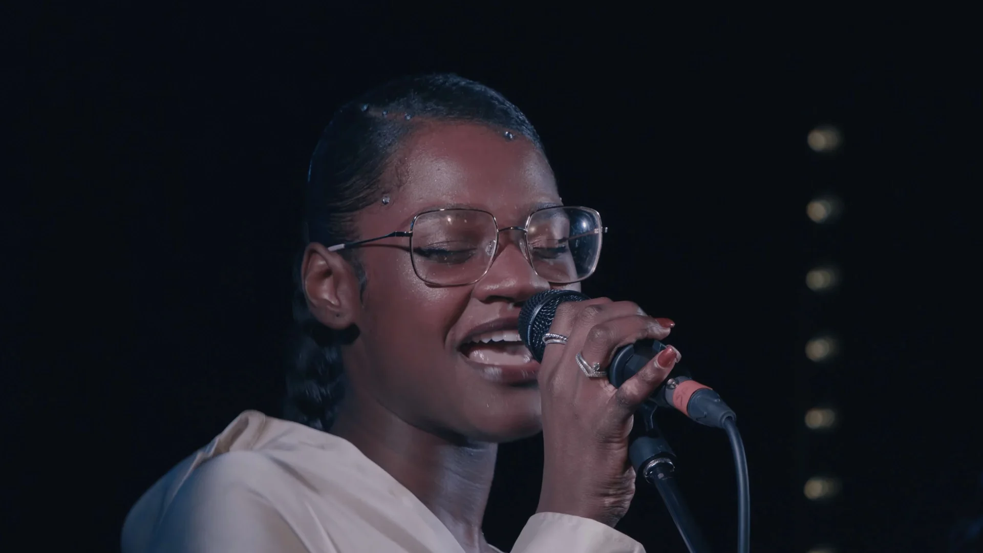 Linda-Ray performing live with a microphone