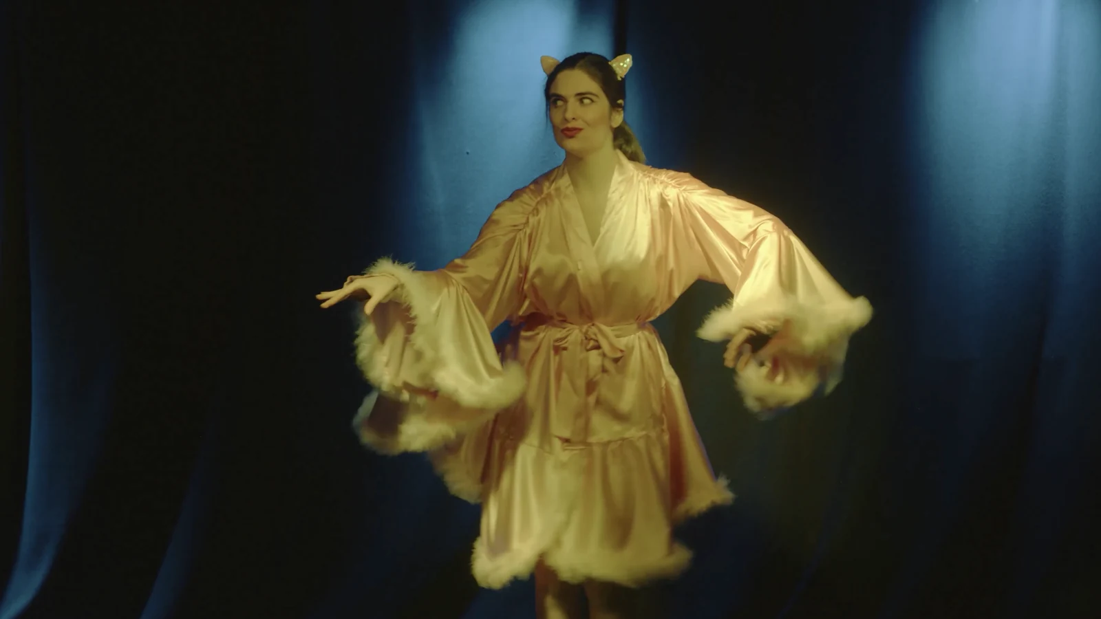 Burlesque performer in a pale satin costume