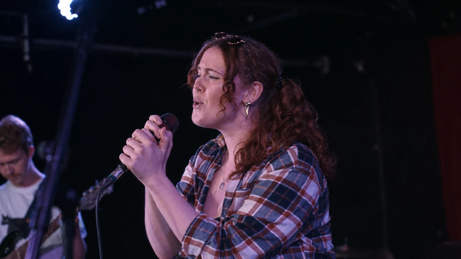 Singer with microphone at The New Age Fundraiser
