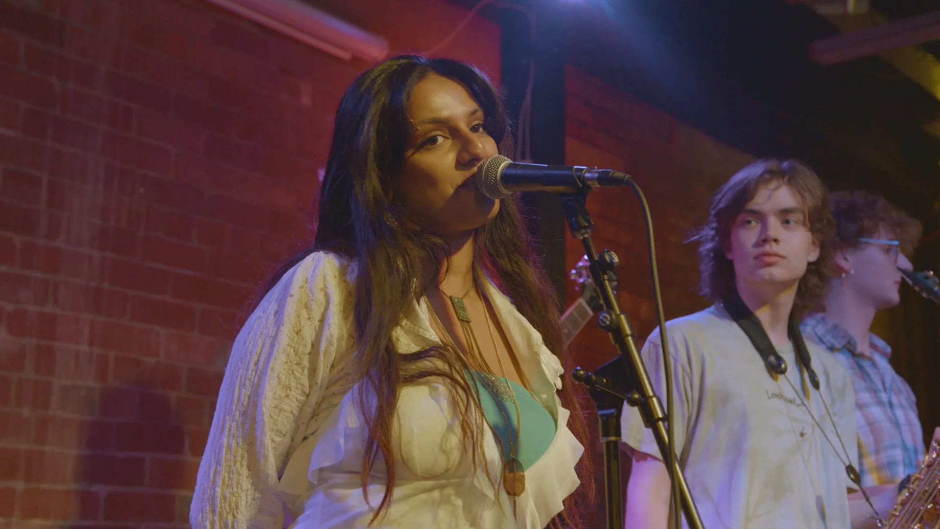 Vocalist performing with musicians at The Showcase