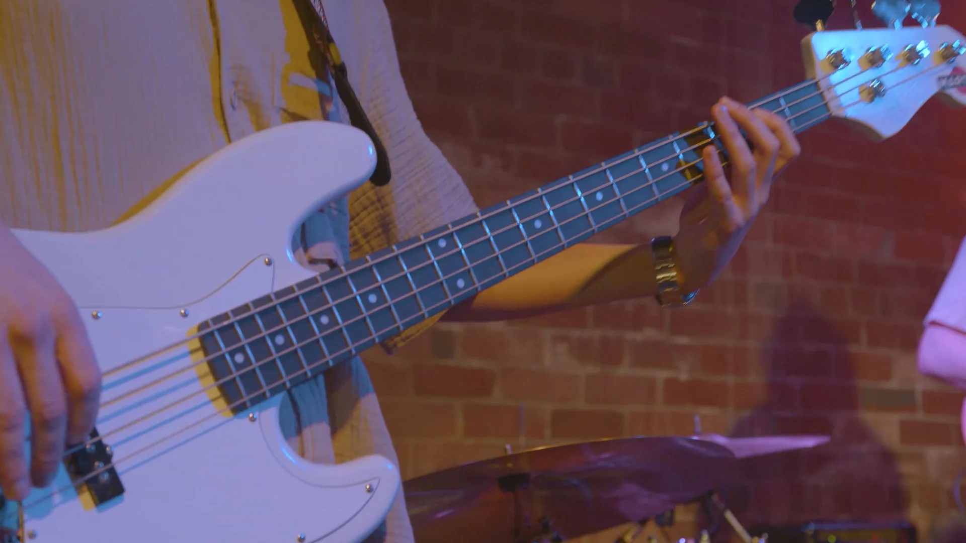 Close view of a bass guitarist performing at The Showcase
