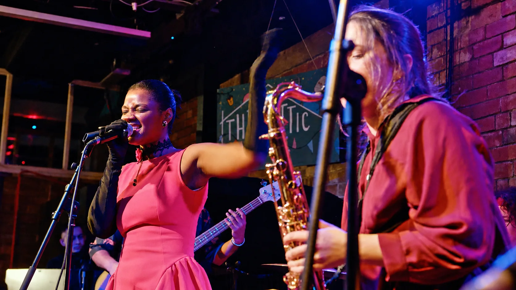 Vocalists and saxophonist performing together at The Showcase