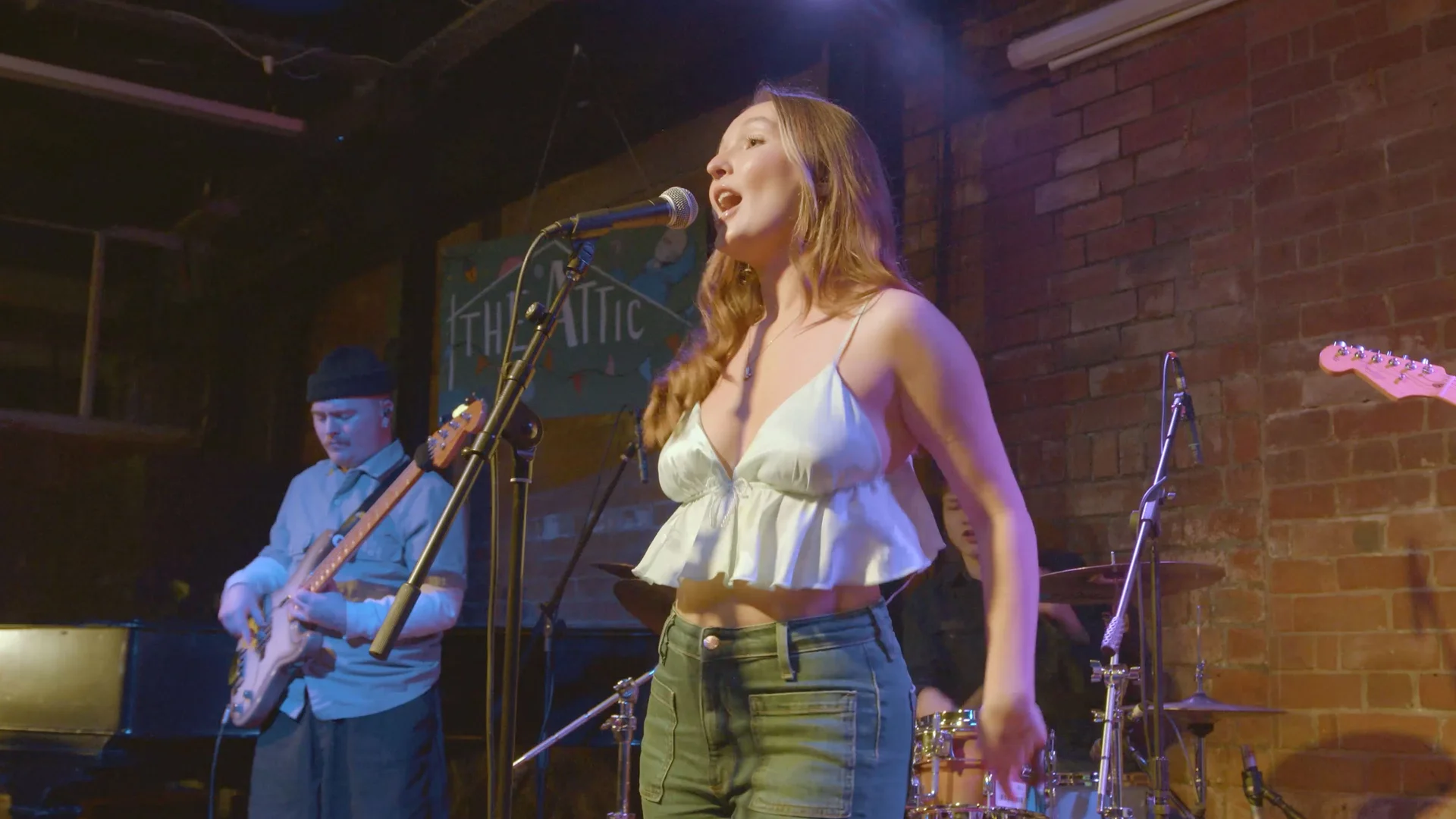 Singer performing with the house band at The Showcase