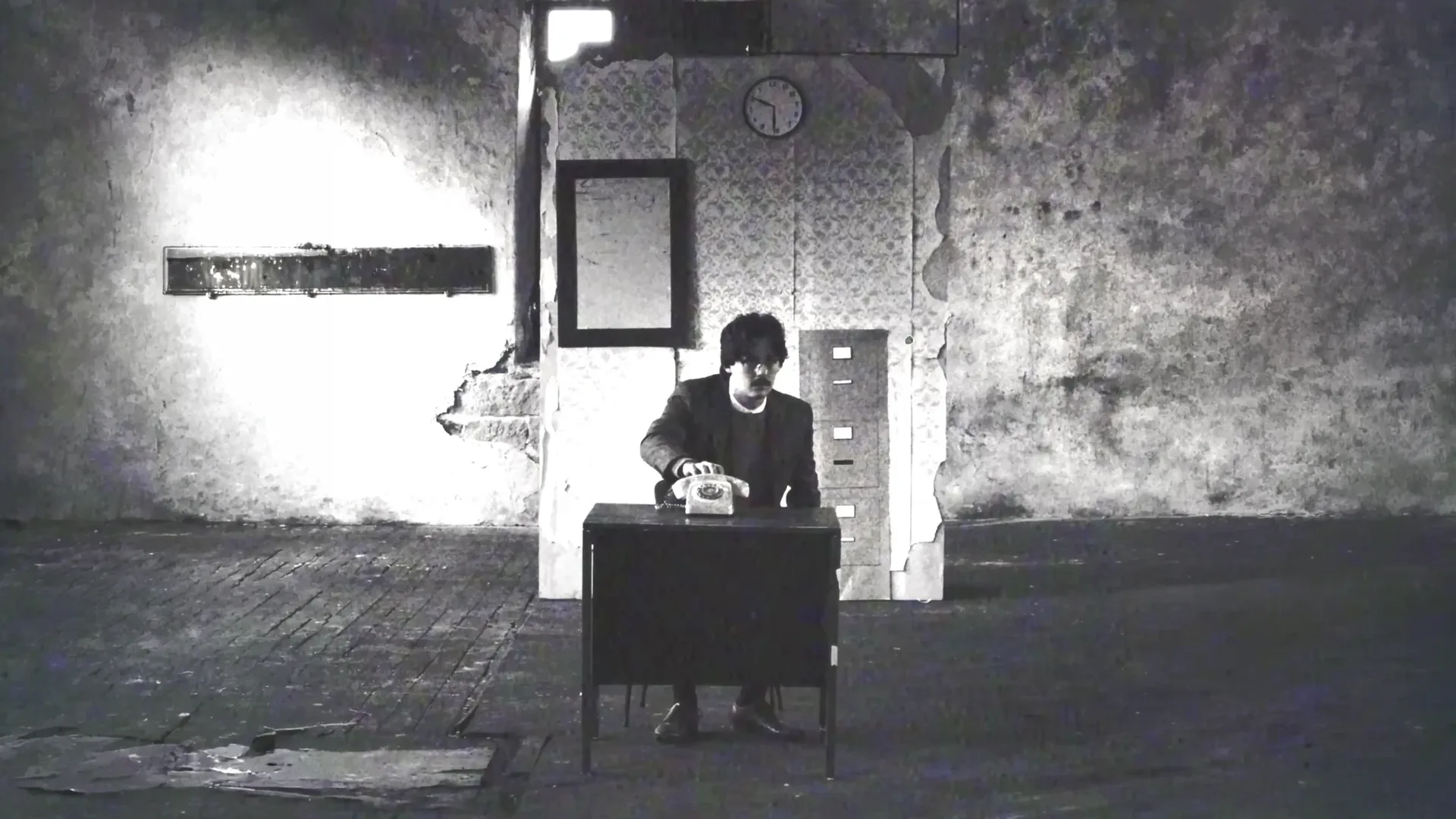 Answer The Telephone v7.1 landscape film still of Adam at the desk